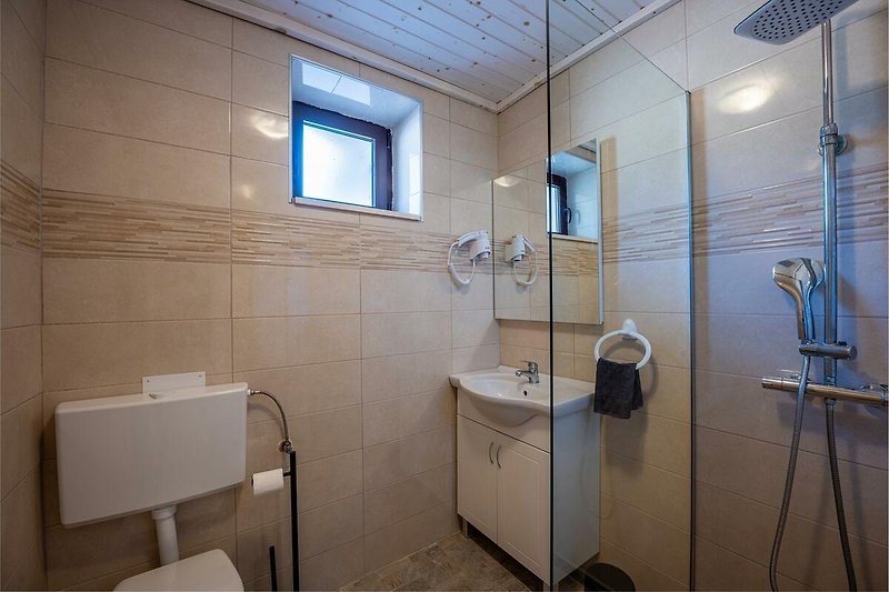 Schönes Badezimmer mit stilvoller Beleuchtung und modernem Waschbecken. Perfekt zum Entspannen und Erfrischen.