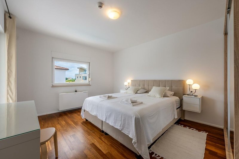 Willkommen in diesem stilvollen Schlafzimmer mit bequemem Bett und gemütlichem Interieur. Entspannen Sie und genießen Sie den Komfort.