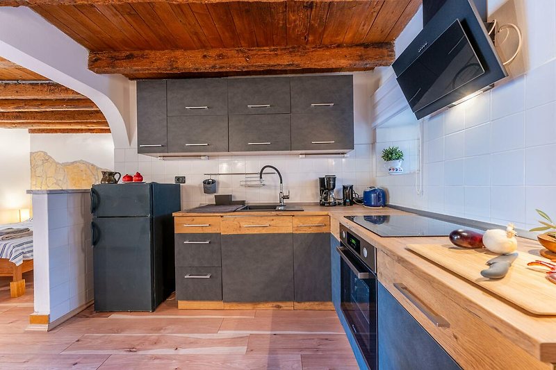 Schöne Küche mit Holzmöbeln, Arbeitsplatte und stilvoller Inneneinrichtung.