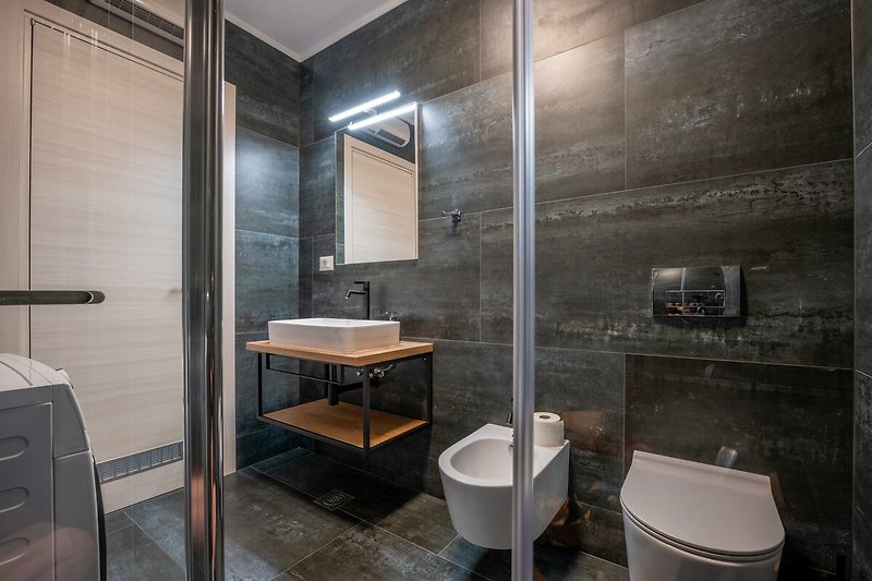 Schönes Badezimmer mit stilvollem Spiegel und modernem Waschbecken.