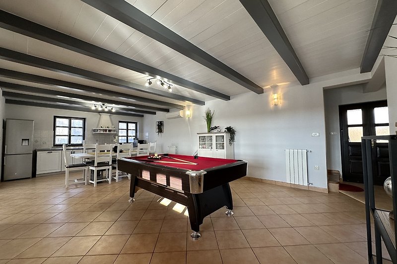 Elegant billiard room with sports equipment and art.