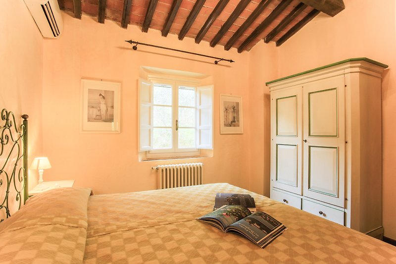 Stilvolles Schlafzimmer mit elegantem Holzbett und Fenster.