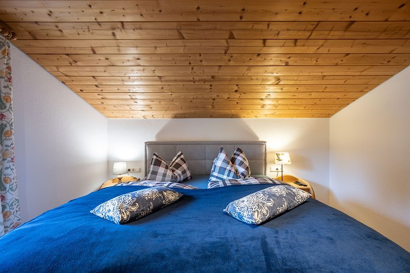 Gemütliches Schlafzimmer mit Holzbalken und stilvollem Interieur.