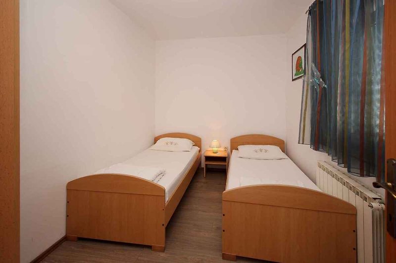 Slaapkamer met 2 éénpersoonsbedden