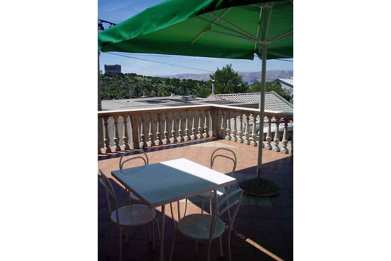 Terrasse mit Gartenmöbel und Sonnenschirm