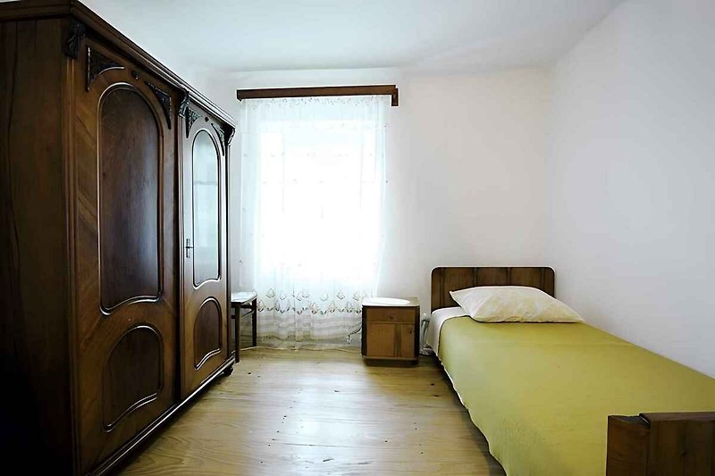 lit simple dans le chambre avec trois lits