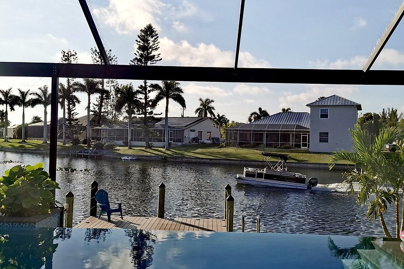 Rent this beautiful property with a stunning view of the water, boats, and lush surroundings.