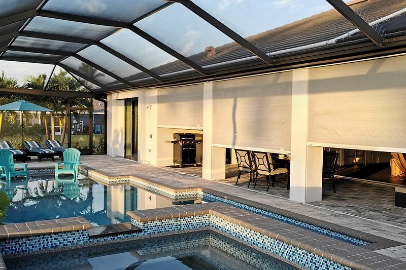 A stunning property with a swimming pool, stylish furniture, and beautiful lighting.