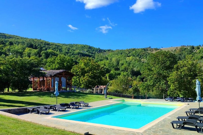 The pool, surrounded by green rolling hills