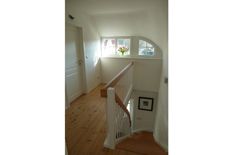The hallway and bedrooms in the attic are equipped with larch wood flooring.