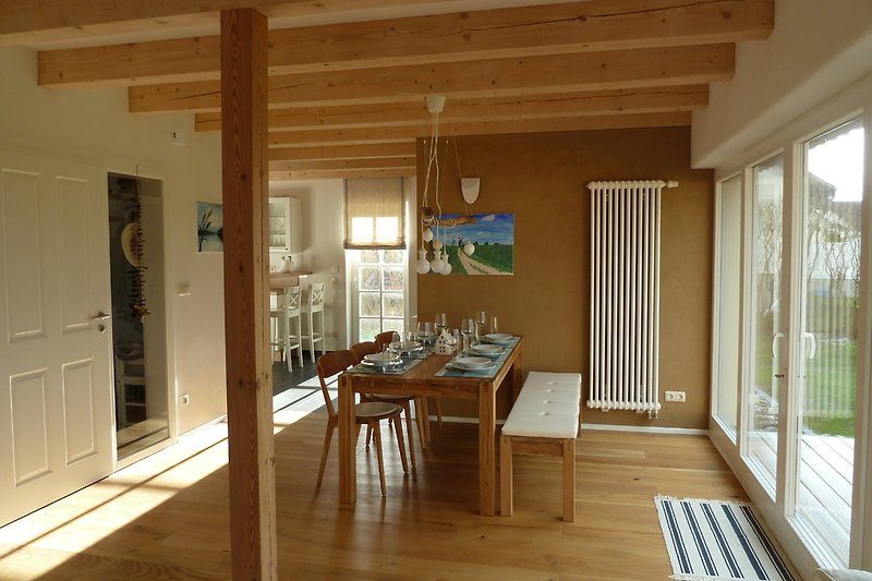 Dining area with oak wood flooring and view of the garden.