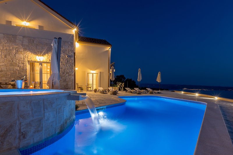 Luxurious seaside villa with stunning ocean views and palm trees.