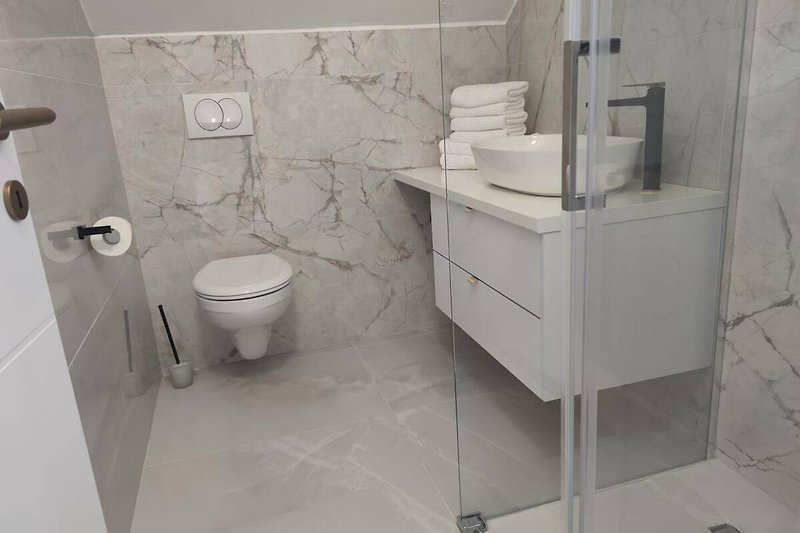 Modern bathroom with sleek fixtures and elegant ceramic sink.
