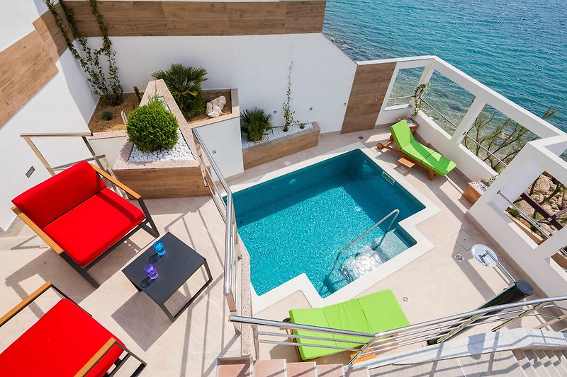 Bird's eye view of the private pool and the sun chairs