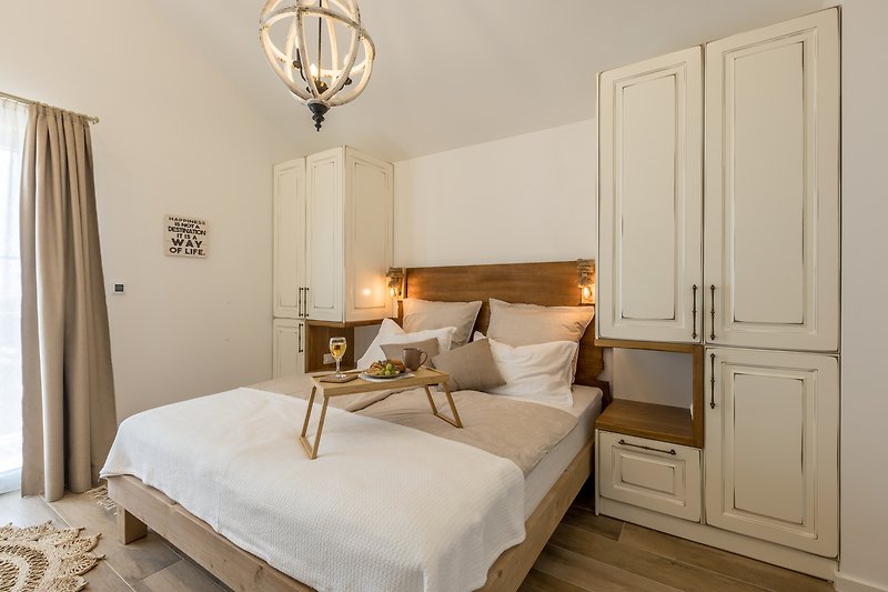 Cozy bedroom with elegant furniture, soft lighting, and stylish decor.