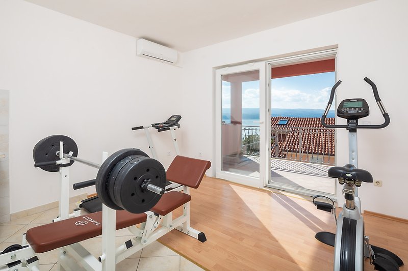 Modern exercise room with balance machine and fitness equipment.