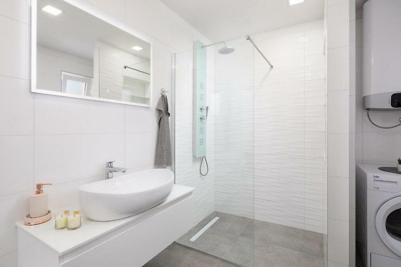 Modern bathroom with sleek fixtures, elegant mirror, and stylish plumbing.