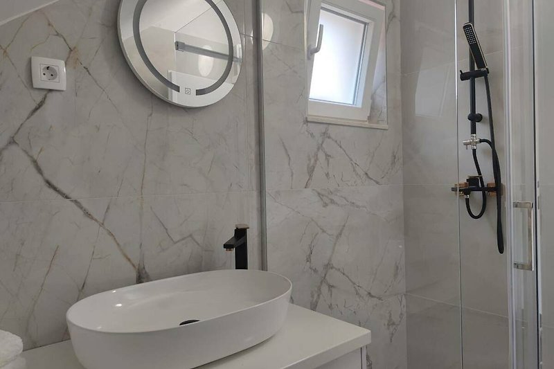 Modern bathroom with elegant fixtures and stylish design.