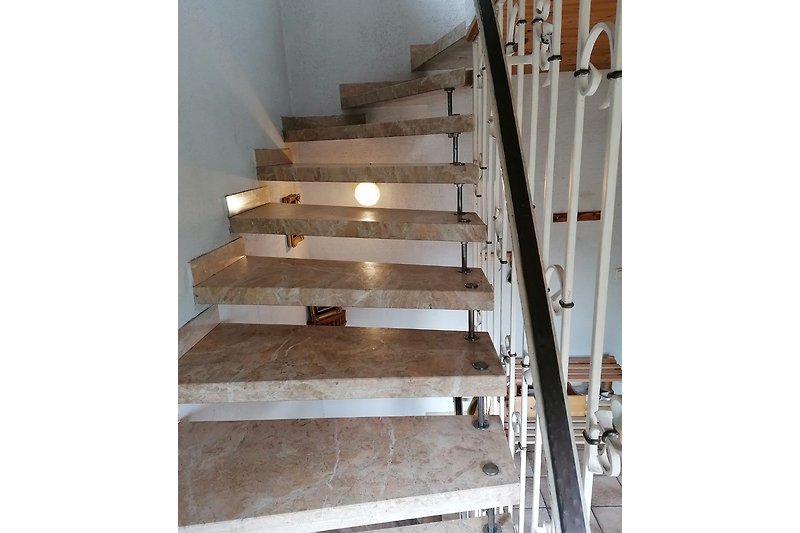 The solid marble staircase linking all floors