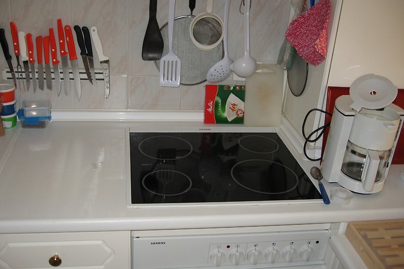 Kitchen with ceramic hob and oven.