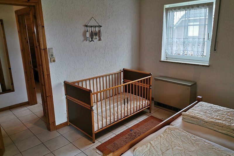 Schlafzimmer 1 mit Blick aufs Kinderbett