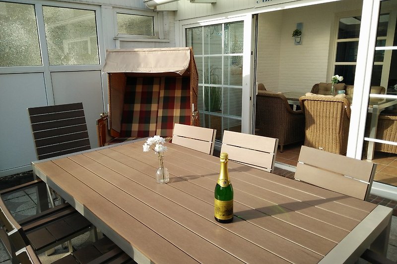 Terrace with garden furniture and beach chair.