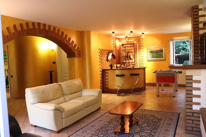 Another view of the large living room with BAR corner, table football and fireplace