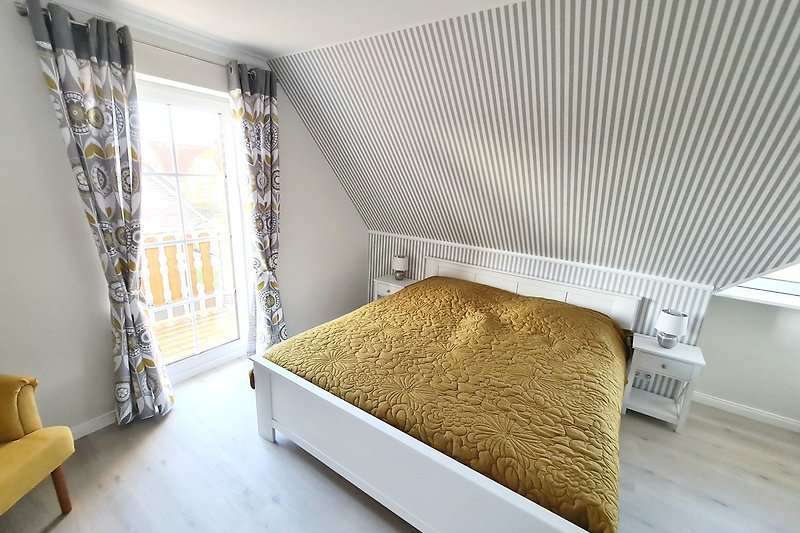Gemütliches Schlafzimmer mit Holzmöbeln und Fensterdekoration.