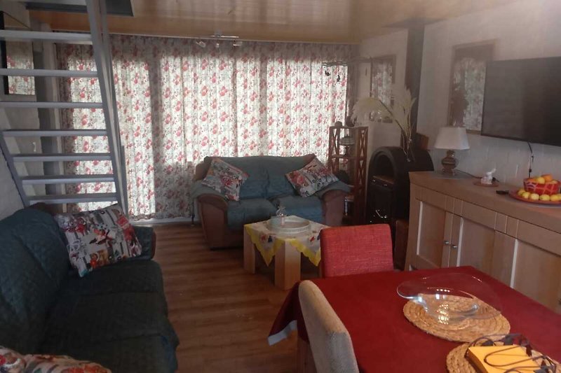Wohnzimmer mit bequemer Couch, Holzmöbeln und Lampen. Gemütliche Atmosphäre.
