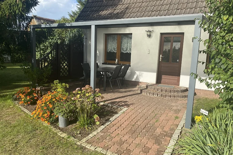 Gemütlicher Garten mit Pergola und stilvollen Gartenmöbeln.