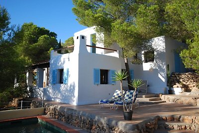 Holiday in Ibiza, nestled between green with ...