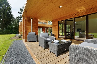 Moderne Hütte mit Holzofen in der Nähe von...