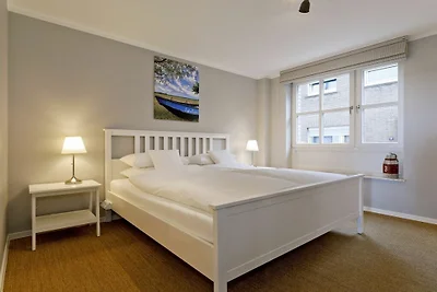 Zalmvissers in hun huisje aan de Rijn