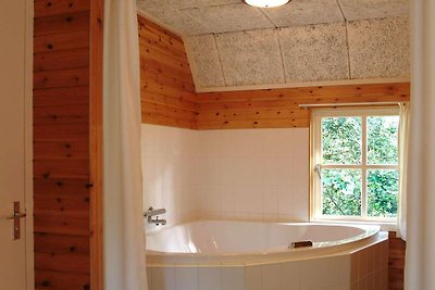 Cozy farmhouse with hot tub located in the...