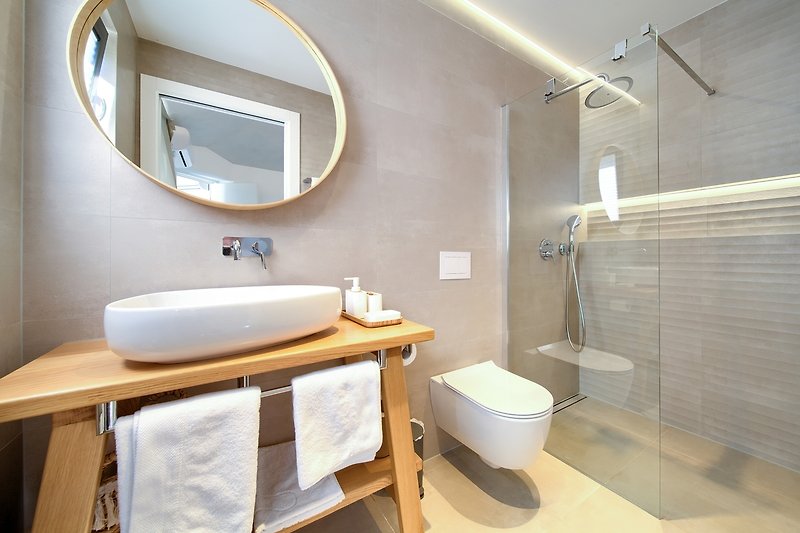 Modernes Badezimmer mit lila Akzenten und hochwertigen Armaturen. Genießen Sie Komfort und Sauberkeit!