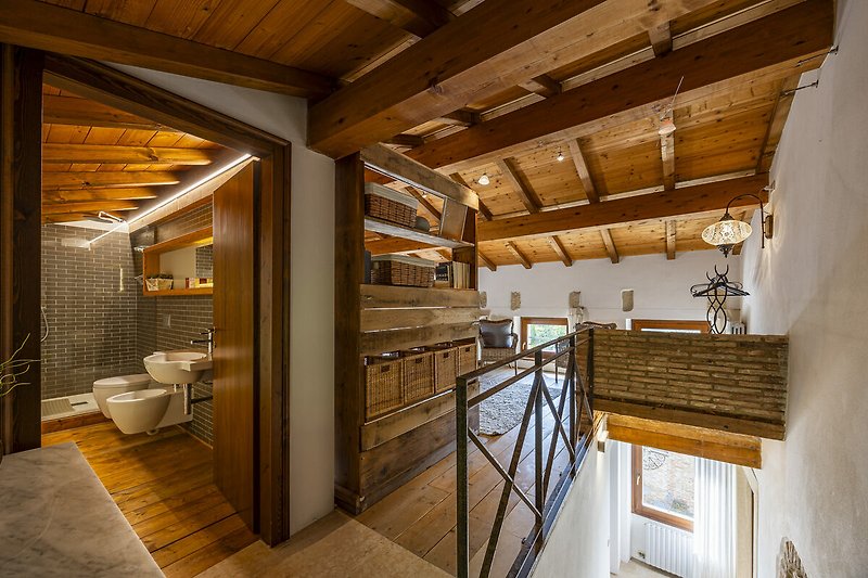 Una casa in legno con pavimenti in legno, travi a vista e finestre panoramiche.