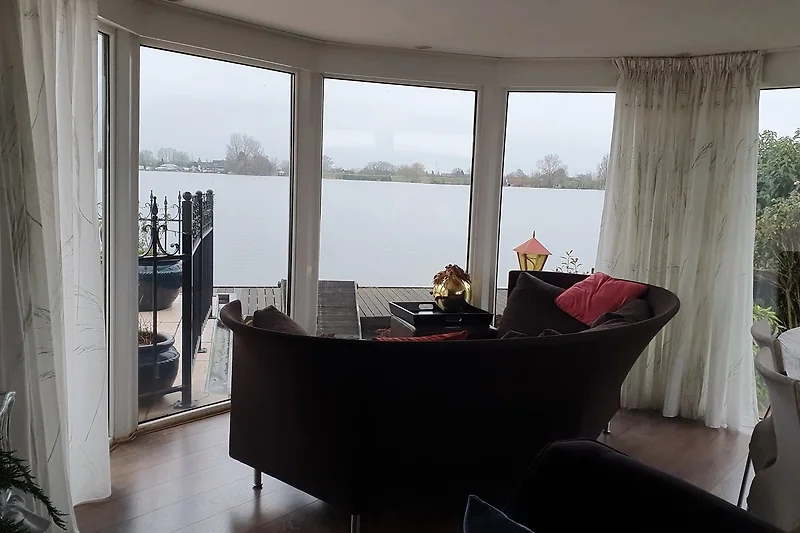 Decke mit auffälligem Leuchtkörper, Glasdetails und Vorhängen.