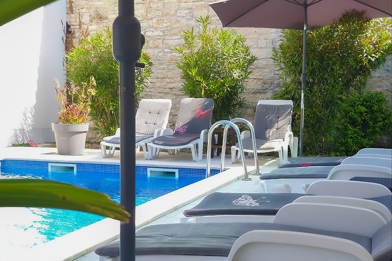 Pool with loungers and parasols.