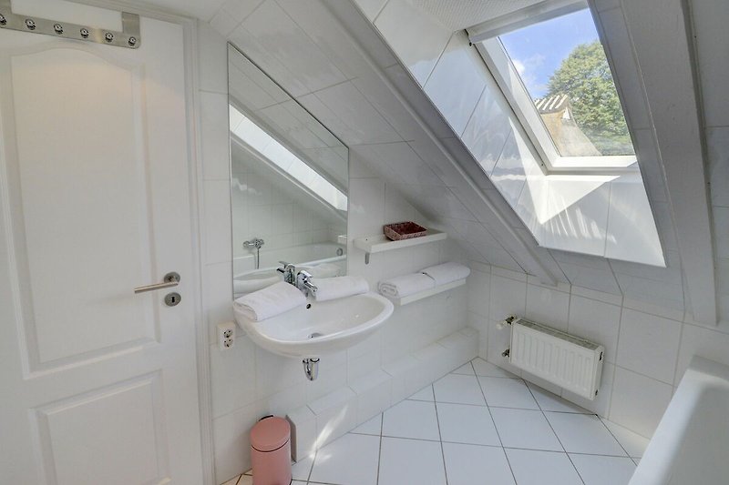spacious, modern bathroom with bathtub