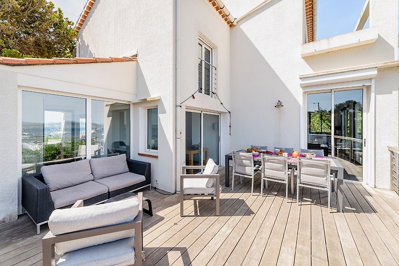Terrasse der Villa mit Liegestuhl und Tisch für 12 Personen - direkt am Meer