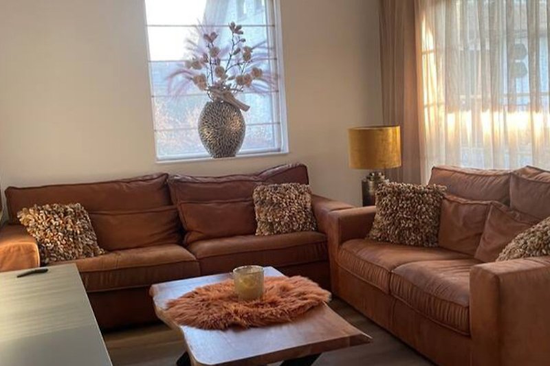Stijlvolle woonkamer met comfortabele meubels en sfeervolle verlichting.