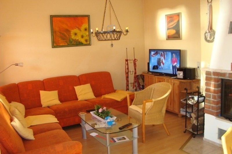 Gemütliches Wohnzimmer mit bequemer Couch, Holzmöbeln und Kamin