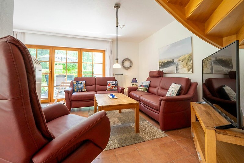 Woonkamer met een comfortabele bank, een salontafel en een groot raam met uitzicht op de stad.