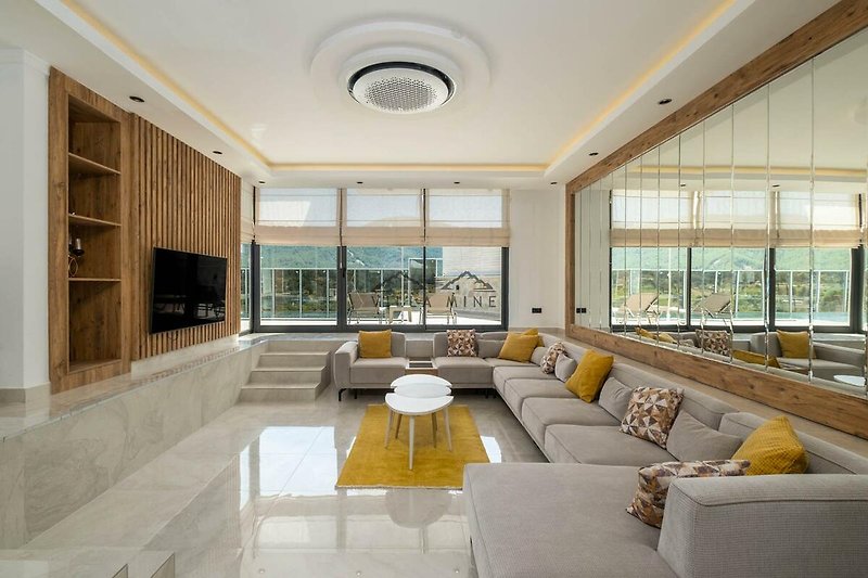Modernes Wohnzimmer mit stilvoller Beleuchtung und elegantem Design. Ideal für Entspannung!