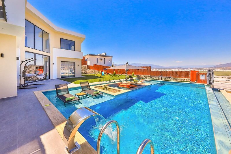 Stilvolles Ferienhaus mit Pool und Blick auf das Wasser.