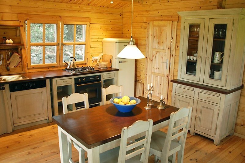 Gemütliche Küche mit Holzmöbeln, Fenster und stilvollem Interieur.