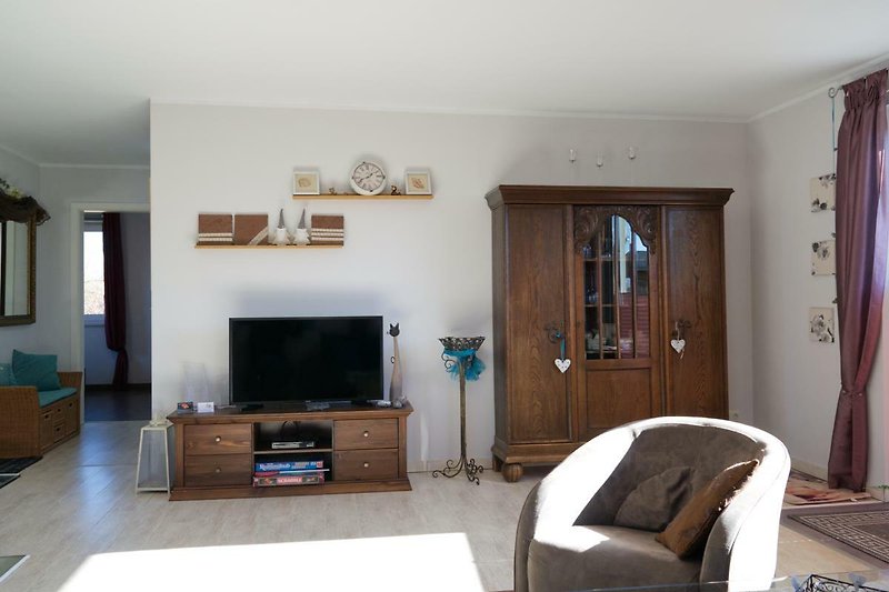 Wohnzimmer mit TV und Schrank im Ferienhaus für 4 Personen auf Fehmarn