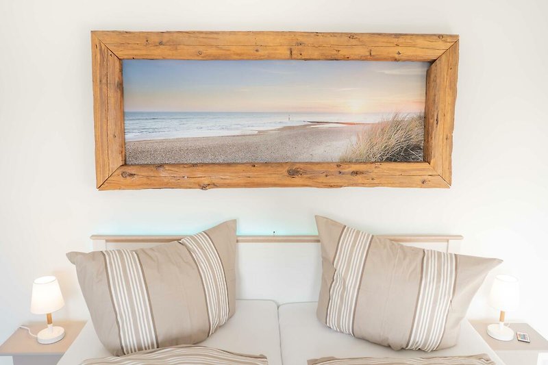 Bild mit Strand und Meer im Schlafzimmer der Ferienwohnung auf Fehmarn