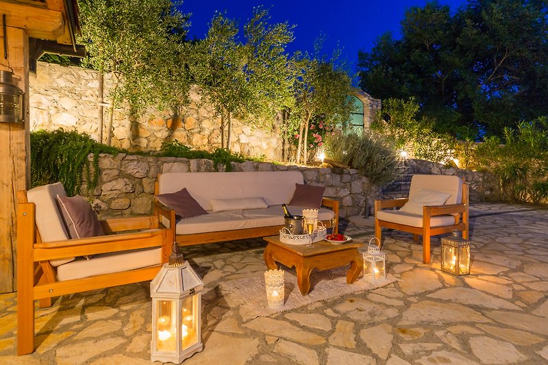 Outdoor living area on the terrace by the pool and olives