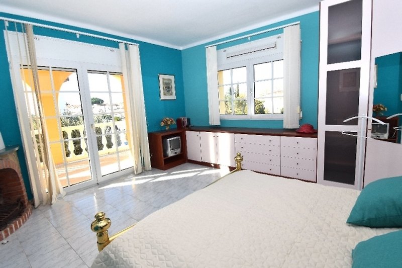 Gemütliche Wohnung mit Holzboden, blauen Vorhängen und bequemen Möbeln.